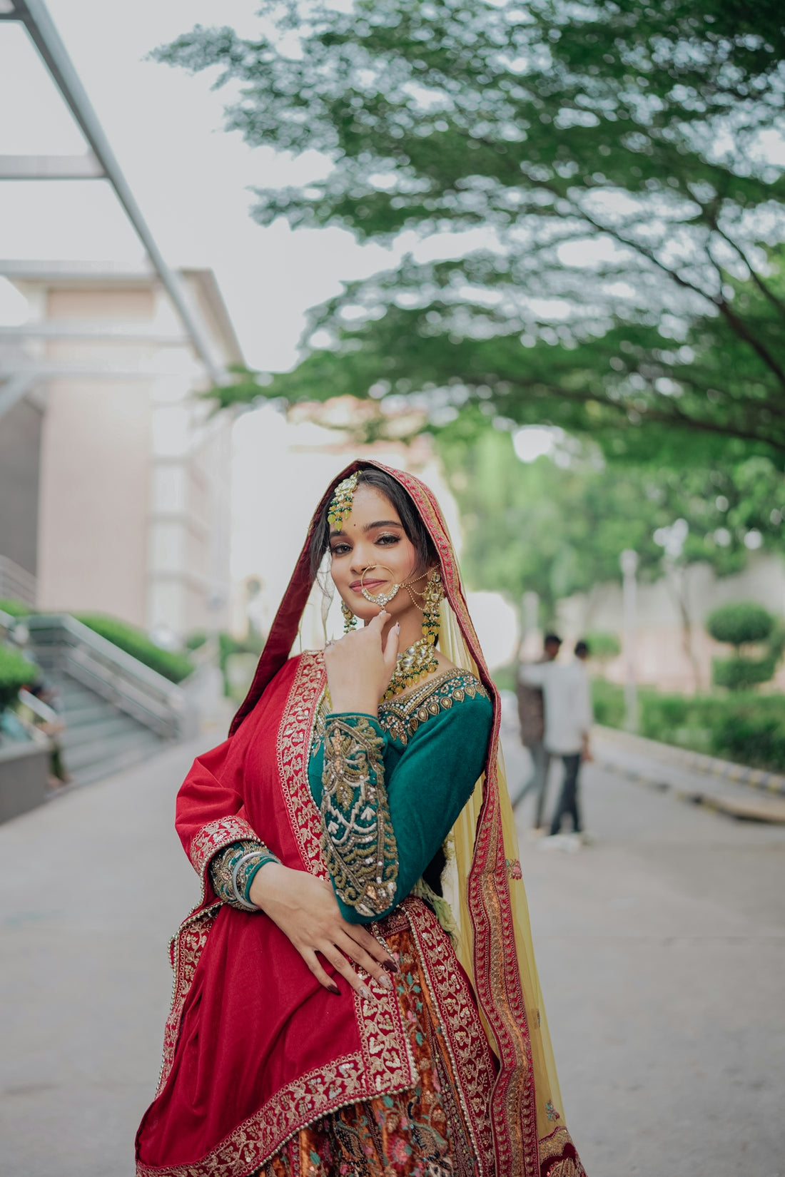 A woman in traditional indian attire smiles outdoors