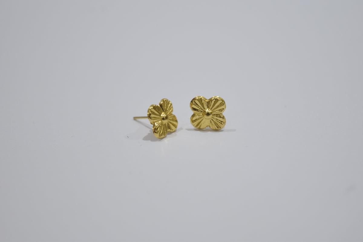 Two gold stud earrings with floral design