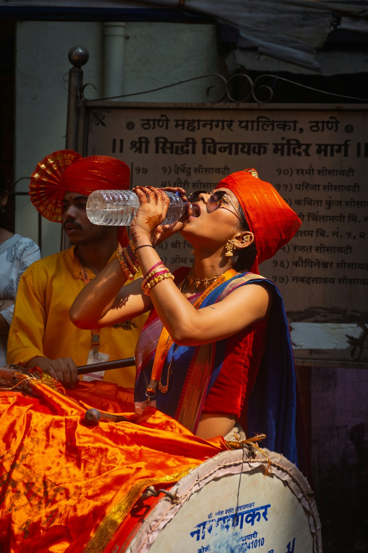 Woman in traditional indian attire drinks water