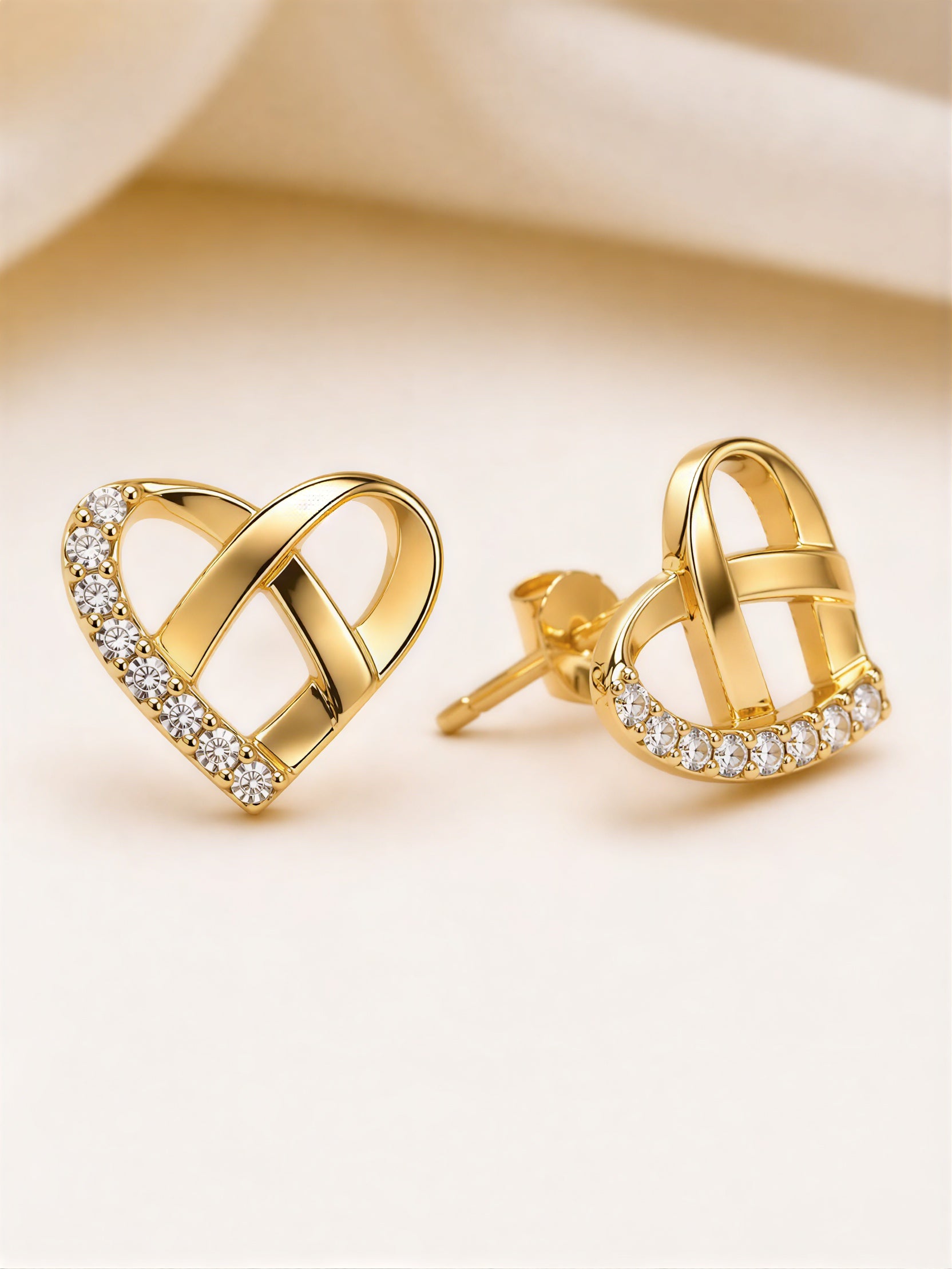 Gold plated heart shape stud earrings with crystal stones