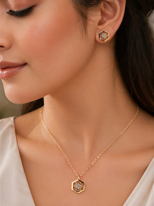 Woman wearing gold plated hexagon pendant necklace and stud earrings, elegant minimal jewellery look