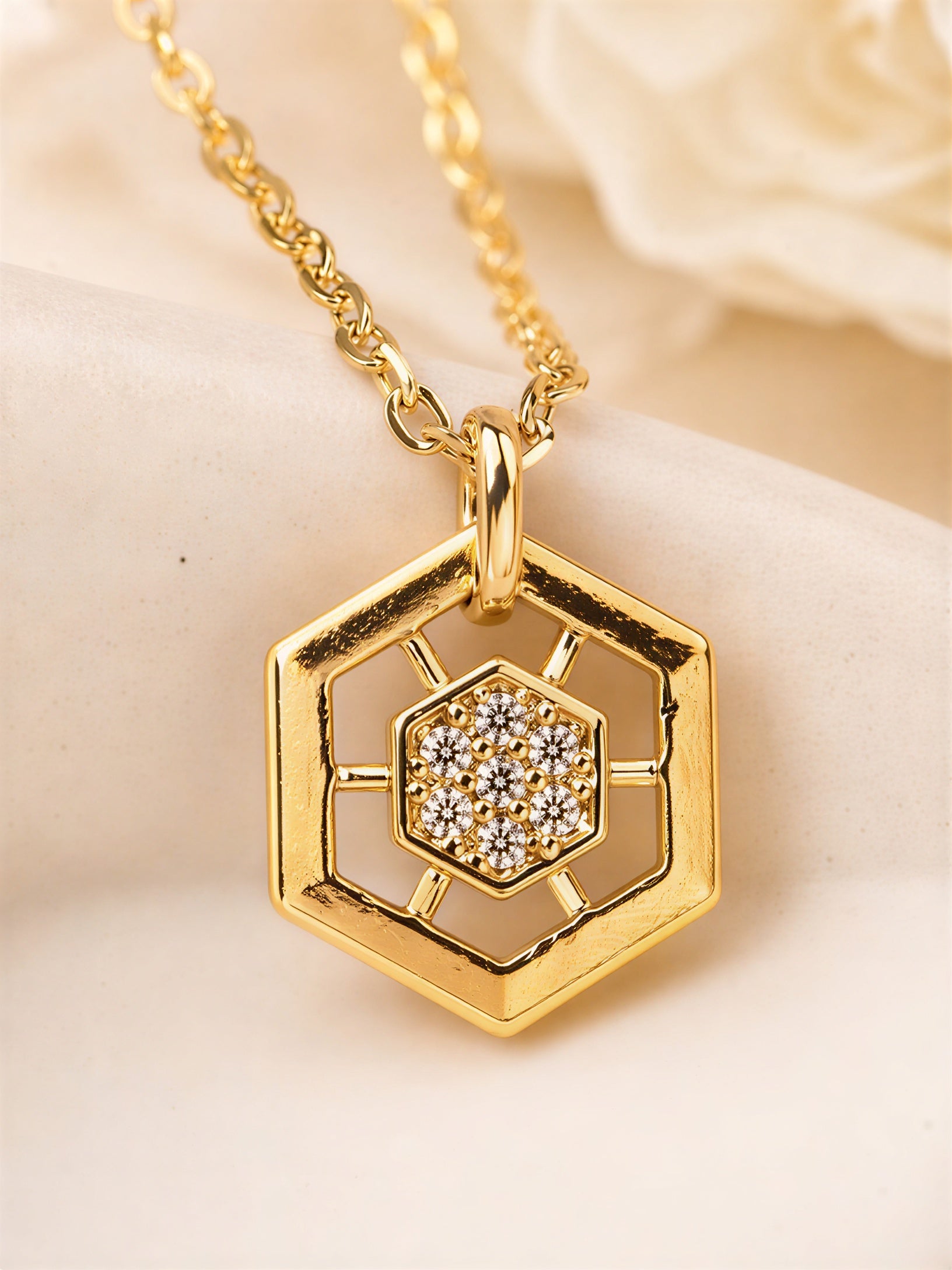 Hexagon shaped gold plated pendant with sparkling stones, modern geometric jewellery design