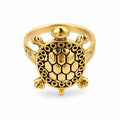Gold plated turtle finger ring close-up view with adjustable brass band for men and women