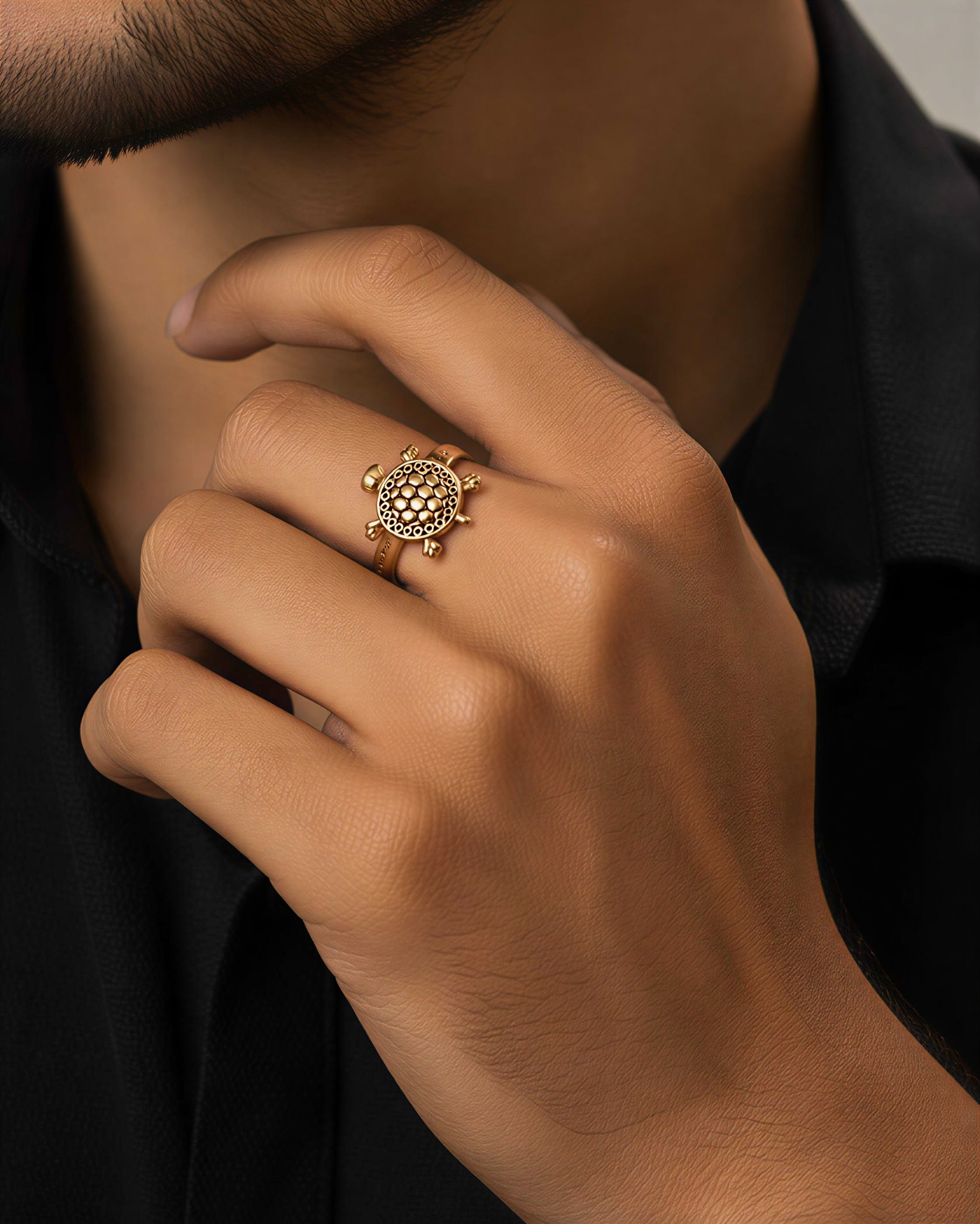 Man wearing gold plated turtle ring stylish unisex fashion jewelry close-up hand shot