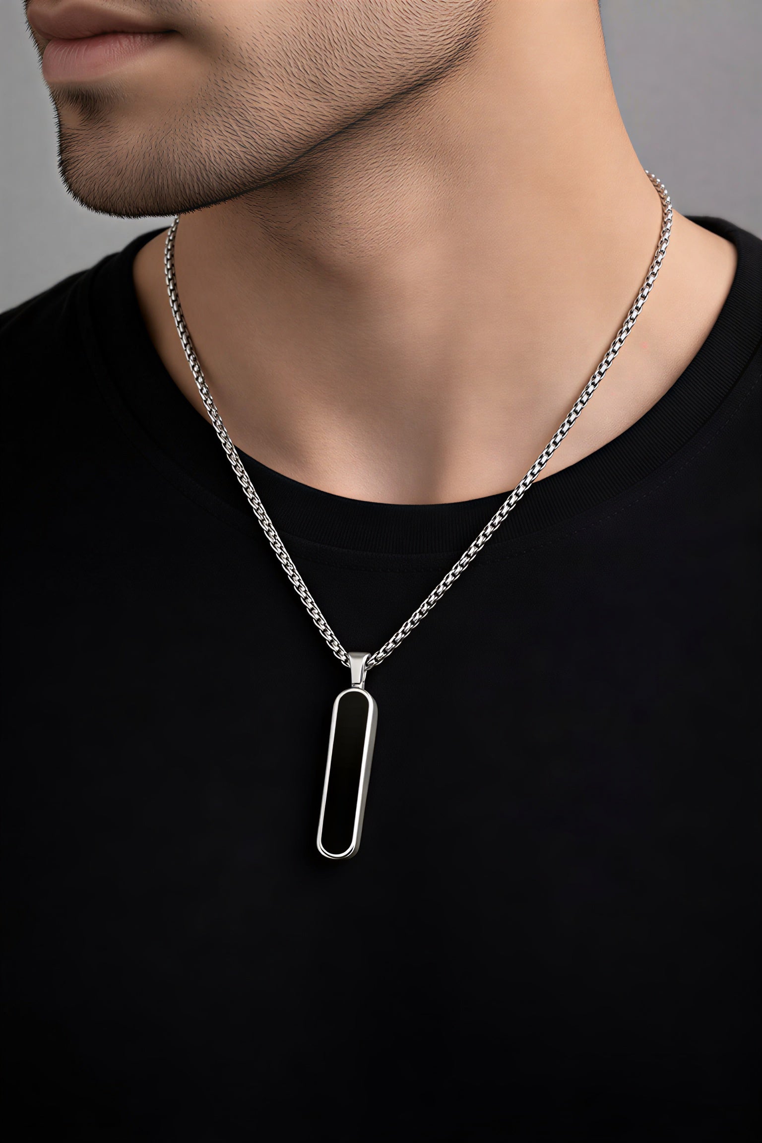 Stylish stainless steel black bar pendant necklace for men with silver chain worn by male model – trendy minimalist men’s fashion jewelry
