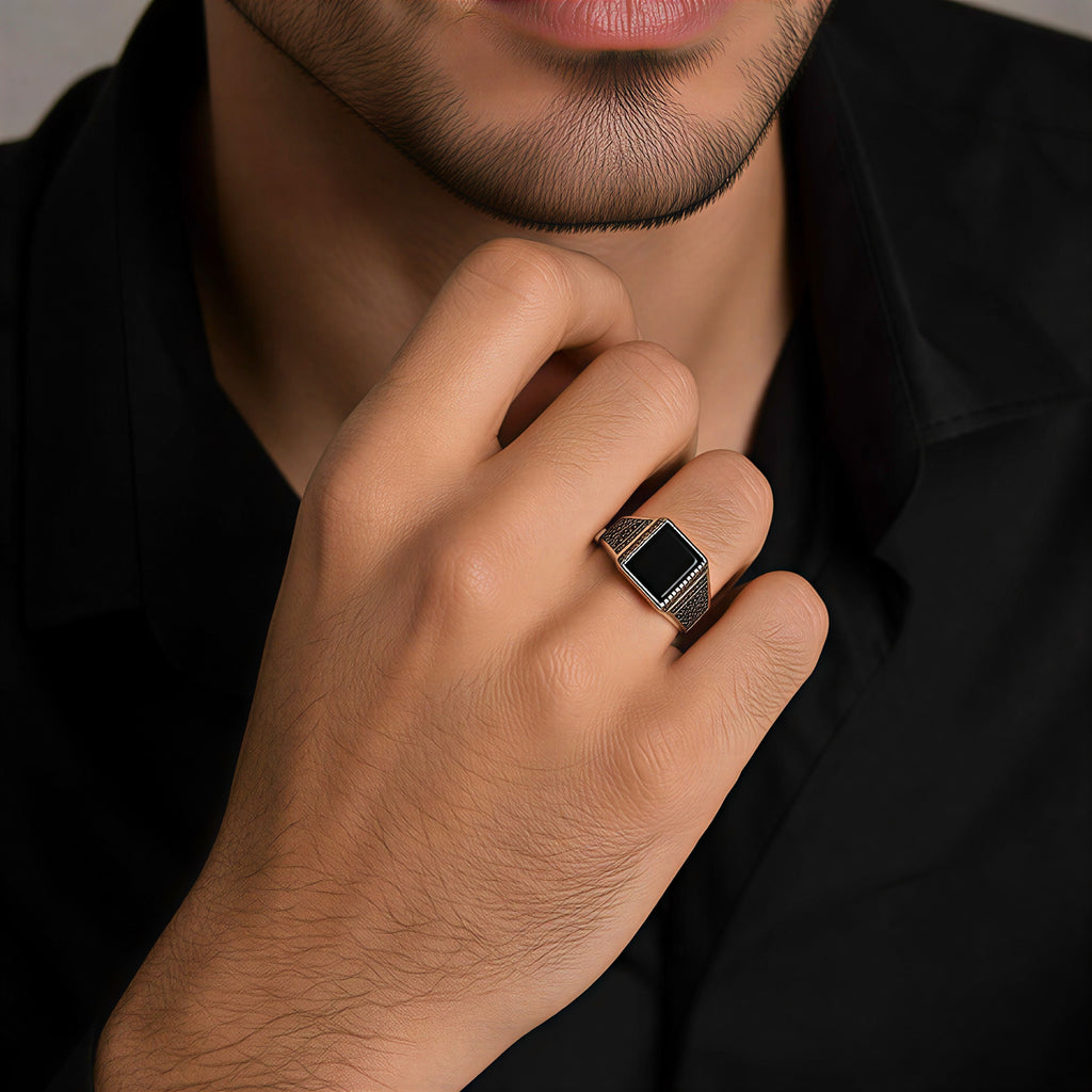 Close-up of male model wearing oxidised black stone statement ring for men fashion styling
