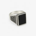 Front view of vintage oxidised black stone signet ring for men with engraved silver design